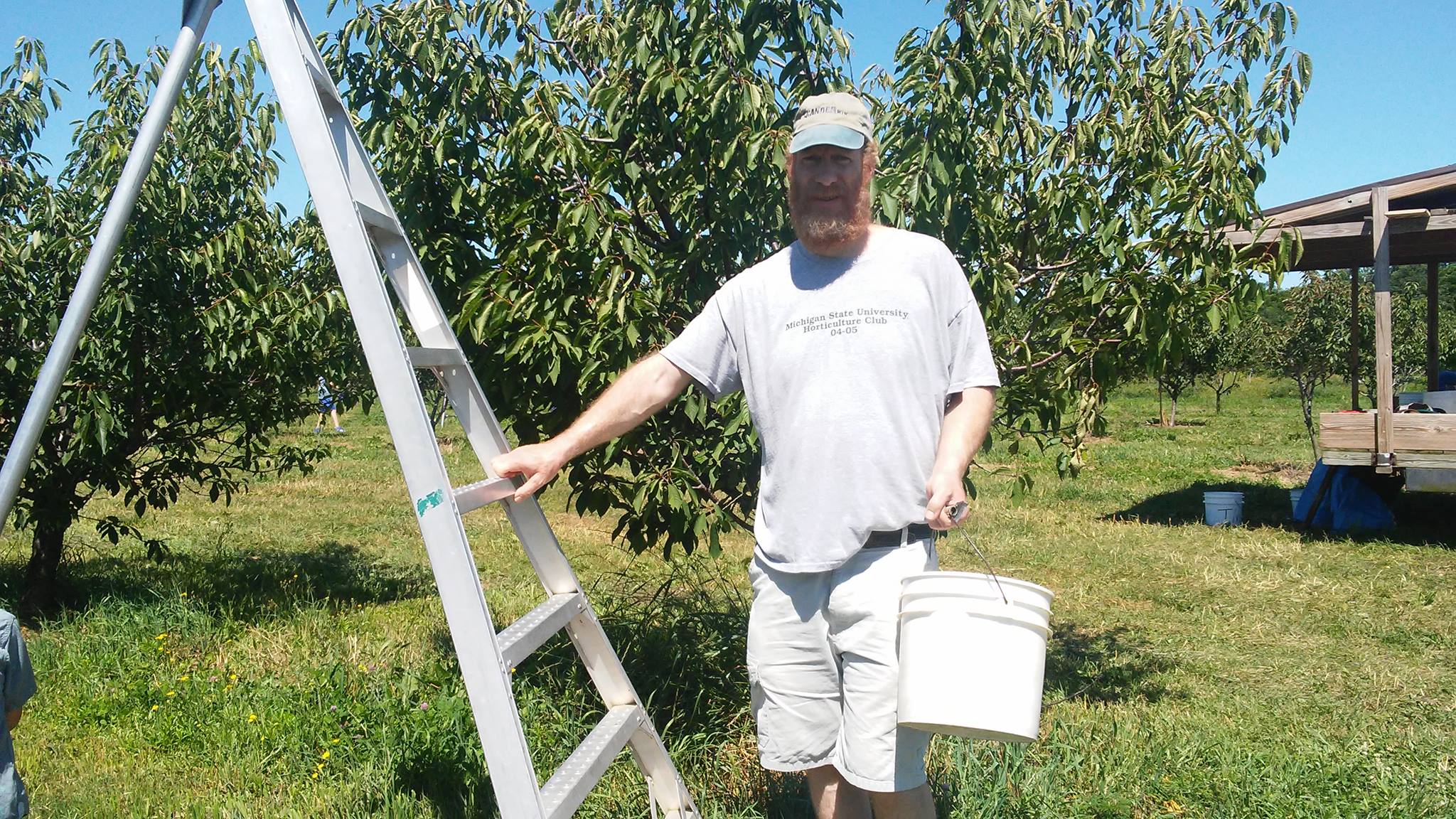 Adam, circa 2017, picking cherries